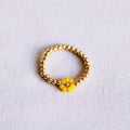 Elastischer Perlenring mit Blume - gelb