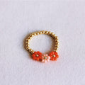Elastischer Perlenring mit 3 Blumen – Koralle/Lachs